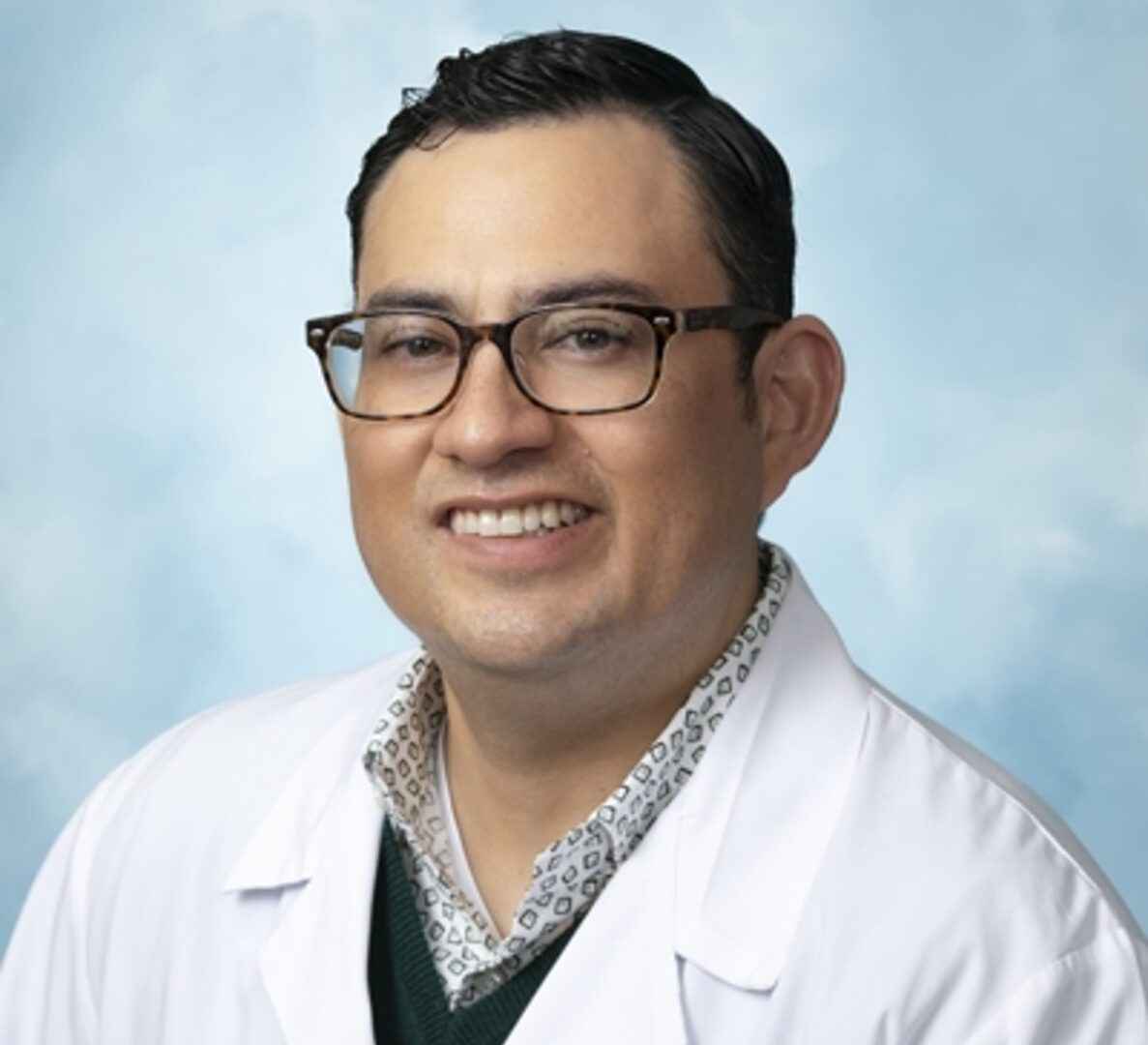 A man in glasses and white lab coat.